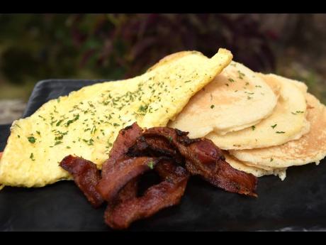 Omelette with a a stack of fluffy pancakes and a side of bacon is available all day. 