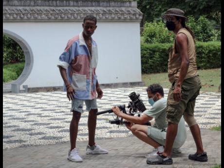 Red Bull Dance Your Style champion Jevaughn ‘Pancho’ Williams takes direction from the crew as film director Yoram Savion (centre) and second camera assistant Jik-Reuben Pringle plan the next move. 