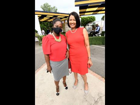 Bethune Lugg-Banton (right), general manager of QNet, and Andrea Messam, chairman, marketing, Cumax Wealth Management, at the unveiling of new signage and launch of Cumax Wealth Management.