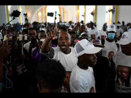 A man yells for justice during a memorial service for assassinated Haitian President Jovenel Moïse in the Cathedral of Cap-Haitien, Haiti, yesterday.