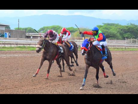 She’s A Wonder (right), ridden by Reyan Lewis, wins the Portmore Cup at Caymanas Park on Saturday, May 1.
