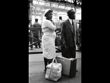 A Caribbean couple on arrival at a UK train station in the 1950s.