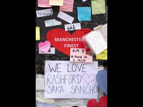 A view of the messages of support left on a mural of Manchester United striker and England player Marcus Rashford, on the wall of the Coffee House Café on Copson Street in Withington, Manchester, England.
