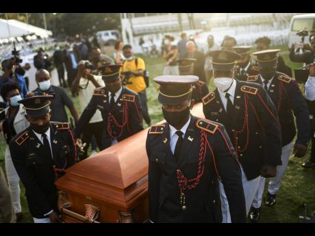 Police carry the coffin of slain Haitian President Jovenel Moïse at the start of the funeral at his family home in Cap-Haitien, Haiti, yesterday.