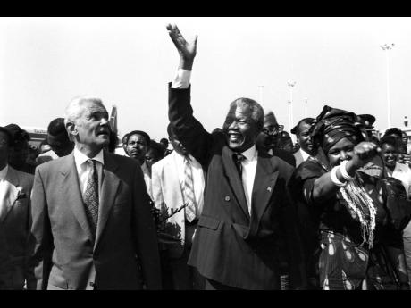 Nelson Mandela, then president of the African National Congress (ANC) of South Africa, waves in appreciation of the tumultuous welcome he received from Jamaicans in the waving gallery and on the tarmac at the Norman Manley Airport on July 24, 1991. Then Pr