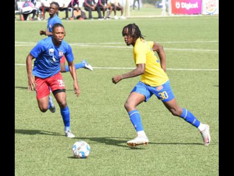 Tevin Scott (right) of Harbour View dribbles past  Dunbeholden’s Mark Miller during their Jamaica Premier League match last Saturday. Harbour View won 2-0.