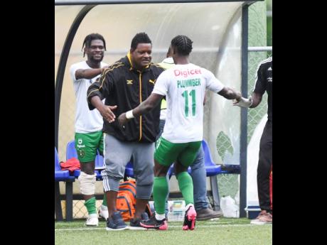 Vere Untied's  Romaine Plummer (back to camera) celebrates with coach Donovan Duckie after scoring the winning goal during their Jamaica Premier League football match, at the Captain Horace Burrell Centre of Excellence at UWI, Mona, on Saturday, August 24.
