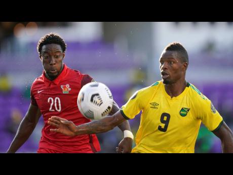 
Jamaica’s forward Corey Burke (9) challenges for the ball with Guadeloupe defender Stevenson Casimir (20) during the first half of their CONCACAF Gold Cup Group C soccer match on Friday, July 16, in Orlando, Florida.