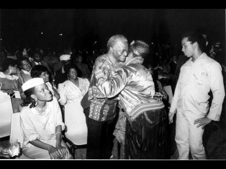 Rita Marley gives a warm welcome to the South African cleric Desmond Tutu when she met him at the cultural concert held in his honour in 1986. At right is her son Ziggy Marley, and, at left, Mpho, the daughter of Tutu.