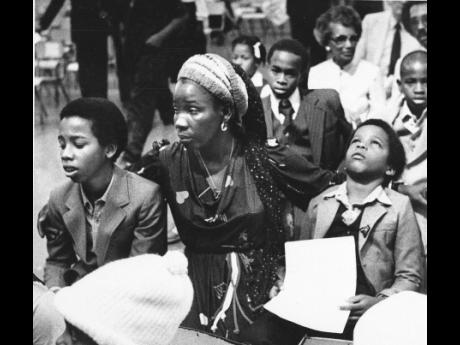Rita Marley, widow of reggae superstar Bob Marley, and her two sons, Ziggy (left) and Stephen, attend Bob Marley’s funeral in Kingston, May 21, 1981. 