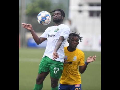
Vere United’s Ricardo Dennis (front) jumps to control the ball as he is challenged from behind by Harbour View FC’s Odorland Harding, during their Jamaica Premier League football match at Captain Burrell Centre of Excellence, UWI, Mona, yesterday. Ver