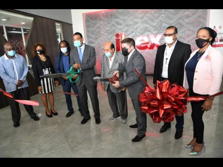 Prime Minister Andrew Holness (fourth left) and Jaime Vergara (third right), country manager of IBEX, cutting the ribbon at the official opening of IBEX building and G-Tech Park by Portmore Holdings Limited in Portmore, St Catherine, last Friday. Others pr
