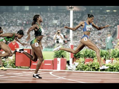 Gold medalist Marie-José Pérec of France (right) crosses the finish line ahead of silver medalist Merlene Ottey of Jamaica (centre) and bronze medalist Mary Onyali of Nigeria during the Women’s 200m final at the 1996 Summer Olympic Games in Atlanta, Ge