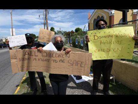 Caroline Dyche (left), No Nine-Day Wonder group member; Yvonne McCalla Sobers (centre), human rights advocate; and Albert Edwards (right), director, Brotherhood of St Andrew, during a protest against gender-based violence, in Liguanea, St Andrew on Thursda