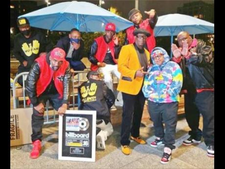 The Wu-Fam in celebration mode with their Billboard plaques.