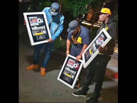 
Members of the Wu-Tang Clan show off the plaques they received for ‘Tropical House Cruises to Jamaica: The Reggae Collector’s Edition’, which hit number 16 on the Billboard Compilation Album chart.