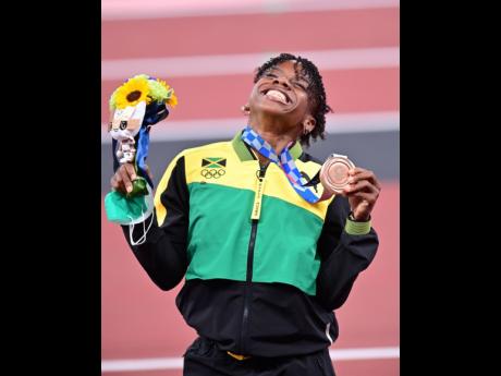 History-making Jamaican Megan Tapper celebrates becoming the first Jamaican female to win a bronze medal in the women’s 100 metres hurdles, during the medal ceremony at the Tokyo 2020 Olympics at the Tokyo National Stadium in Tokyo, Japan, yesterday.