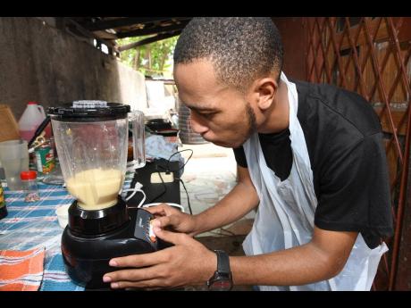 Checking for the consistency in the mix, the chef blends the boiled ackee with condensed milk and vanilla until smooth.