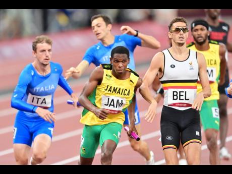 
Jamaica’s anchor-leg runner, Nathon Allen(second left), sets off after receiving the baton from Jaheel Hyde (in background), during the men’s 4x400 metres relay final at the Tokyo 2020 Olympic Games, at the Tokyo Olympic Stadium in Tokyo, Japan, yeste