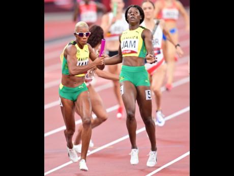 Jamaica’s Candice McLeod (left) receives the baton from teammate Shericka Jackson during the final of the Women’s 4x400m Relay at the Olympic Games in Tokyo, Japan, on Saturday.