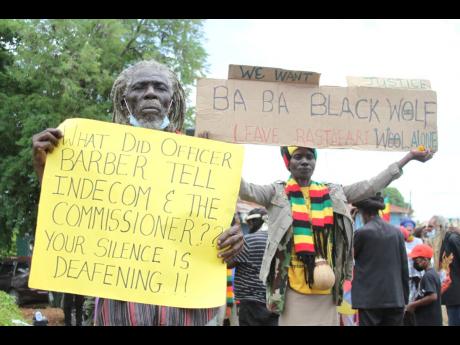 Members of the Nyabingi Order protest close to the Four Paths Police Station in Clarendon, seeking answers on an alleged case of a police officer trimming the dreadlocks of Rastafarian teen Nzinga King while she was in police custody.