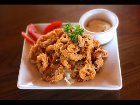 For patrons who indulge in seafood, a serving of fried calamari, battered to perfection, enhances the sensory quality and is sure to kick-start appetites.
