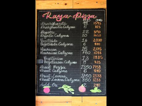 The menu board at Kaya Pizza, located on Lady Musgrave Road, is filled with options. 