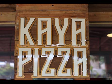 In big, bold letters, the Kaya Pizza sign welcomes customers. 