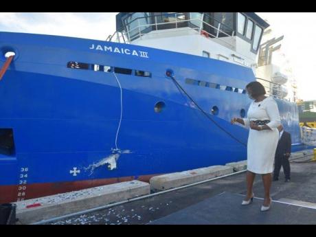 Member of Parliament for East Rural St Andrew Juliet Holness smashes a bottle of champagne against the side of the ‘Jamaica III’ Utility Vessel, during the official commissioning and christening of the Port Authority of Jamaica boat at Newport East, Ki