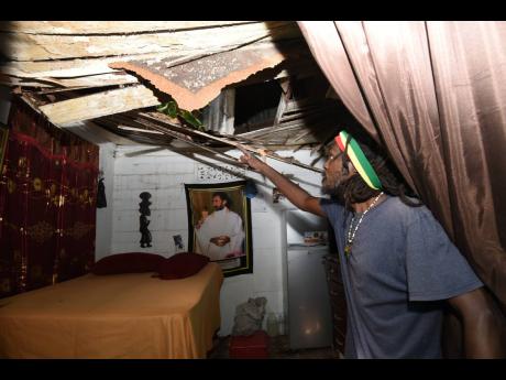 Marlon Sutherland is happy to be alive after a mango tree fell on his house at 95 Mark Lane just after midnight Tuesday. The tree that stood for more than forty years snapped after a day of wind and rain generated by Tropical Storm Grace.