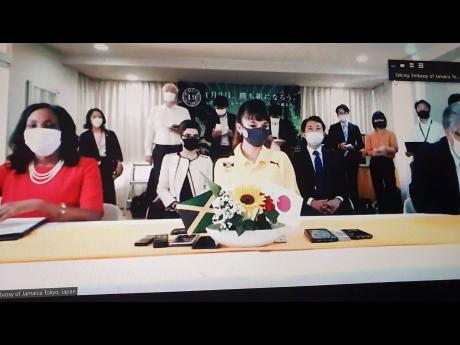Tijana Kawashima (right) and Jamaica’s ambassador to Japan, Shorna-Kay Richards (left), are watched by Japanese dignitaries and media during an official ceremony announcing an invitation for Kawashima to visit Jamaica.