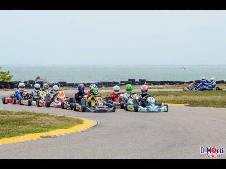 A bunched up pack of karters get ready to take the green flag at the Palisadoes Gokart track.