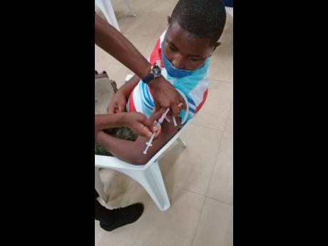 Obryan Peters, 12, of Priory Primary and Infant School, getting his vaccine. 
