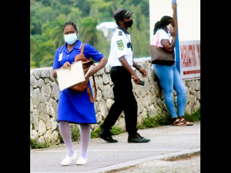 A student nurse leaves the nurses quarters at the Cornwall Regional Hospital on Wednesday. Operations at public hospitals across the island were crippled by a sickout, with Cornwall Regional itself among the worst  affected.