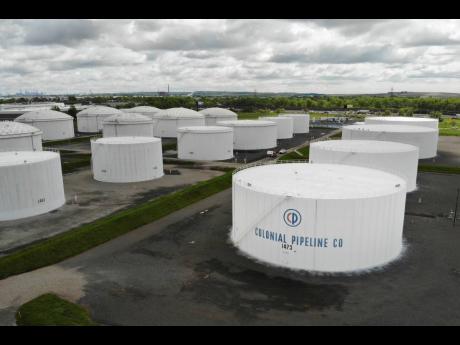 
Colonial Pipeline storage tanks are seen in Woodbridge, N.J., Monday, May 10, 2021. Gasoline futures are ticking higher following a cyberextortion attempt on the Colonial Pipeline, a vital US pipeline that carries fuel from the Gulf Coast to the Northeast