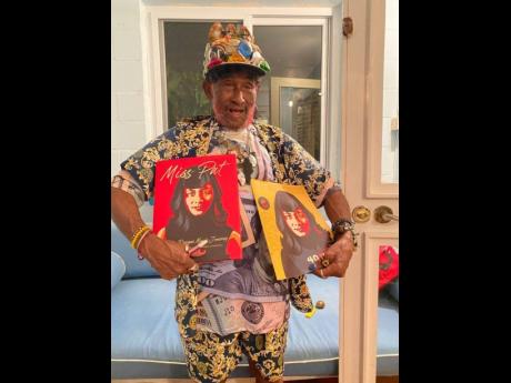 Lee ‘Scratch’ Perry proudly shows off his friend and former partner Patricia Chin’s book. Chin visited him in mid-July.