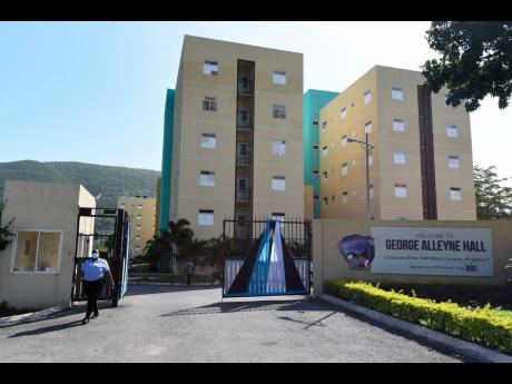 A security guard exits the grounds of the George Alleyne Hall at The University of the West Indies, Mona. Residents of 138 Student Living halls have been ordered to move out if not vaccinated by September 3.