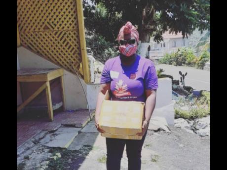 Dr Tamika Peart delivering one of several care packages to households in St Ann.