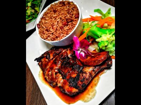 Drum pan jerk chicken served with rice and peas and steamed vegetables.