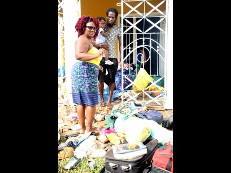 Christal Campbell and Greg Nesbeth of Fyall Estate, Four Paths, Clarendon, are happy to be alive after they escaped through a hole in the wall last Friday to get to higher ground due to flooding associated with Tropical Storm Ida. 