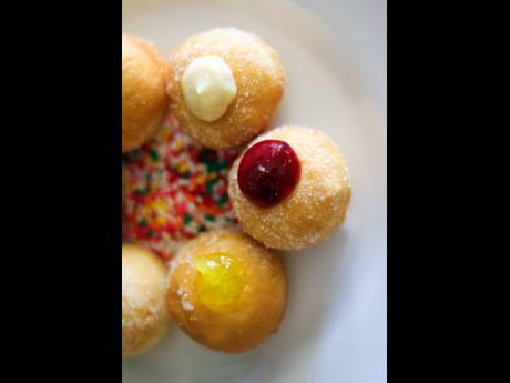 These doughnut holes filled with fruity preserves, are bite-sized versions of the fried pastry.