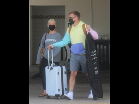 Tourists arrive at the Sangster International Airport in Montego Bay on Thursday. Tourism interests have given the thumbs down to Mark Golding’s recommendation that all tourists be vaccinated.