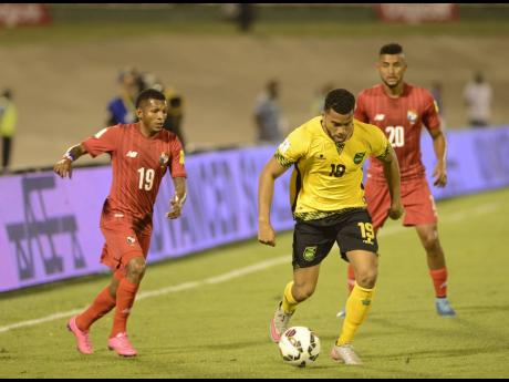 
Jamaica’s Adrian Mariappa (centre) breaks away from Panama’s Alberto Quintero (left), while Anibal Godoy also of Panama looks on during the CONCACAF Semi-final round Group B World Cup Qualifying football match at the National Stadium on Friday, Novemb
