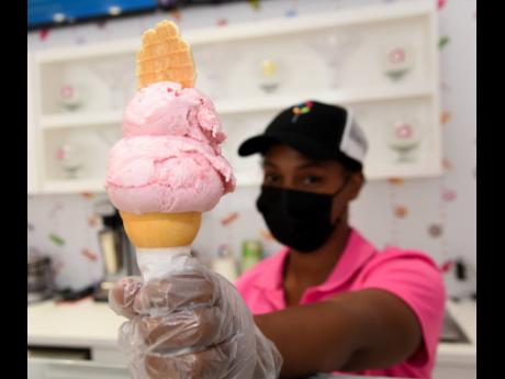 Petagayle Johnson, a staff member at the new Candy Craze location, serves their bestselling ice cream flavour – strawberry.