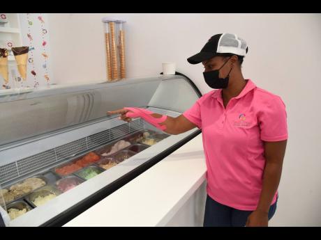 Petagayle Johnson explains the different flavours of ice cream  at Candy Craze Barbican.