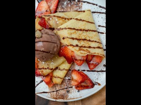 Strawberry Nutella crepe topped with chocoate ice cream. 