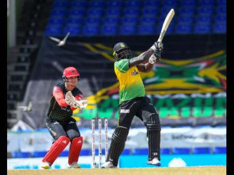 Kennar Lewis (right) of Jamaica Tallawahs hits six runs as St Kitts and Nevis wicketkeeper Joshua Da Silva looks on during their Hero Caribbean Premier League match at Warner Park Sporting Complex in Basseterre, St Kitts and Nevis, yesterday.