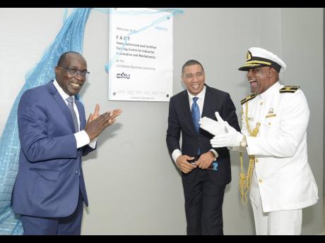 Prime Minister Andrew Holness (centre) is seen here with Ruel Reid and Professor Fritz Pinnock at a September 2018 dedication ceremony at the Caribbean Maritime University. Reid and Pinnock are still earning millions annually while on leave because of a co