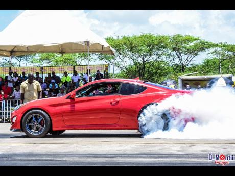 The Hyundai Genesis of Roland Crawford doing a burnout.