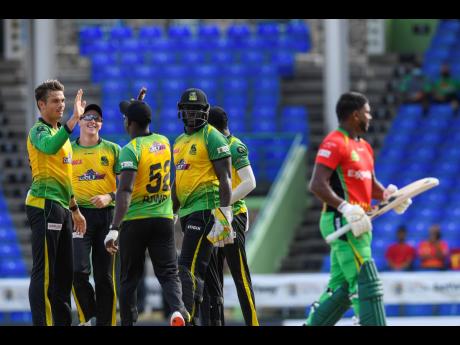 Chris Green (left), Migael Pretorius (second left) and Kennar Lewis (fourth left) of Jamaica Tallawahs celebrate the dismissal of Chanderpaul Hemraj (right) of Guyana Amazon Warriors during the2021 Hero Caribbean Premier League match between Jamaica Tallaw